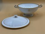 a white bowl with a gold rim and a white bowl with a gold rim