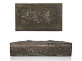 pair of carved metal boxes with horses and flowers on them