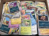 a box full of pokemon cards sitting on the floor