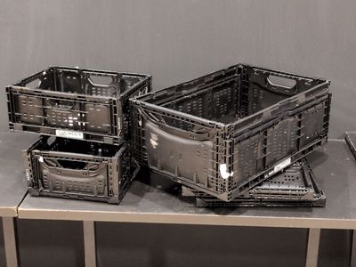 three plastic containers sitting on top of a metal table