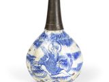 an old blue and white vase with a picture of a man on a horse