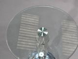 a glass table with a glass top on a white table cloth