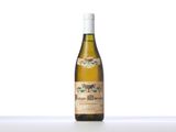a bottle of white wine sitting on top of a table