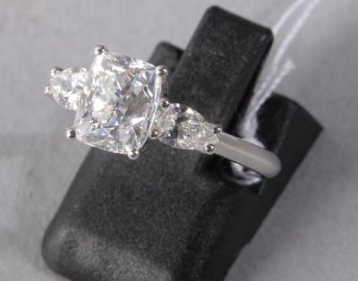 an image of a diamond ring on a black ring holder