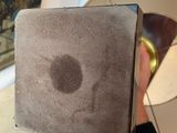 a person holding a piece of paper with a hole in it