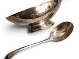 two spoons and a bowl on a white surface