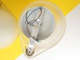 yellow and white striped table with a light bulb and a lamp on it