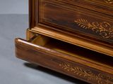 a close up of a wooden chest of drawers