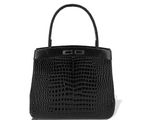 a black crocodile skin handbag on a white background