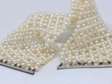 two pieces of white pearls and a pair of silver hair clips