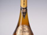 an old bottle of wine sitting on top of a white table