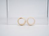 pair of white gold wedding rings in a clear acrylic box