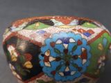 a close up of a colorful vase on a table