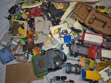 a pile of toy cars and other toys on a bed