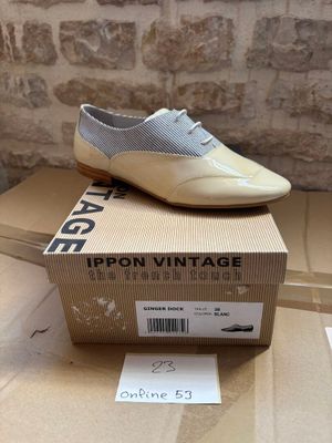 a pair of shoes sitting on top of a cardboard box