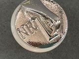 a close up of a silver coin with a picture on it