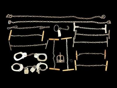 a group of metal chains and shacks on a black background