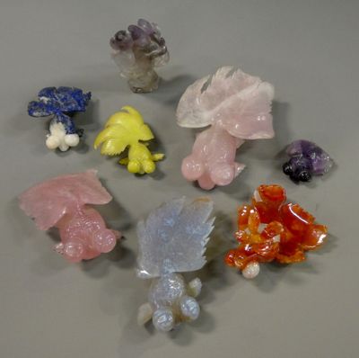 a lot of different colored crystal figurines sitting on a table