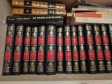 a lot of books that are on a shelf