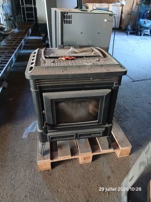 a stove that is sitting on a pallet in a garage