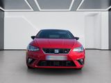 the front of a red car in a white room