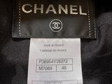 a chanel black jacket with a gold logo on the front