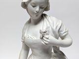 a statue of a woman holding a bird in her hand