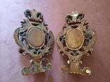 two antique mirrors on a table with a pink table cloth