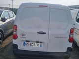 a white van parked in a parking lot with other cars