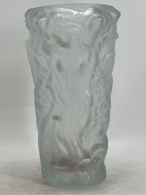 a close up of a frosted glass vase on a white surface