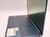 a laptop computer sitting on a table with its lid open
