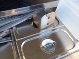 a metal sink with a metal lid and a plastic container