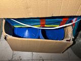 a cardboard box with two blue plastic barrels inside of it