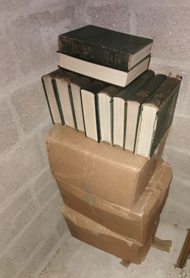 many books stacked on top of each other in a room