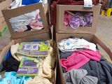 two boxes full of clothes sitting on top of each other