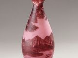 a vase that has a picture of a mountain scene on it