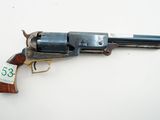 an old revolver with a tag on it sitting on a table