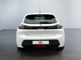 the rear end of a white car in a white room