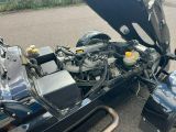 a black car with a large engine and a black car with a yellow top