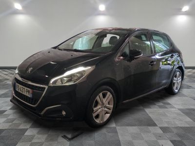 the black car is parked in the garage on a checkered floor
