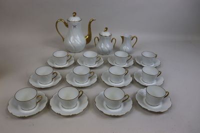 a lot of cups and saucers sitting on a table