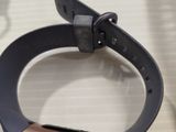 a smart watch on a table next to a pair of scissors
