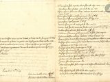 un vieux document sur lequel figurent des inscriptions est ouvert à une page