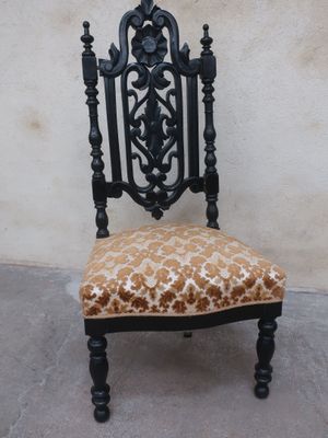 a chair with a leopard print seat and a black frame