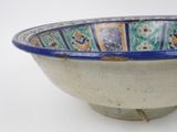 a blue and white bowl sitting on a white surface