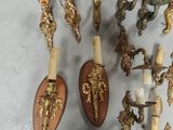 many different types of wall sconces on the wall