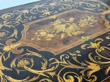 a black and gold table with gold decorations on it