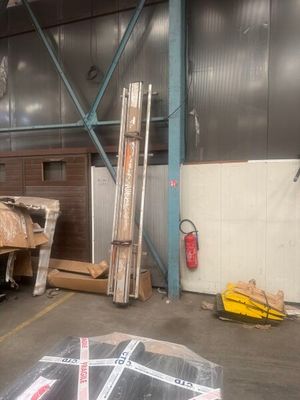 a truck that is parked in a warehouse with a lot of boxes