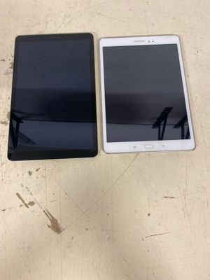 two cell phones are sitting next to each other on a table