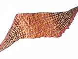 a piece of cloth with a design on it on a white surface